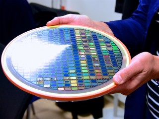 A wafer of microdisplay chips that has been made as thin as a human hair in order to allow the individual chips to be bent.