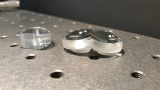 Thineyes® optical train for the LOMID project. On the left is an aspheric doublet lens and on the right a freeform lens. The LOMID optical architecture uses 2 aspheric and one freeform lens per eye, in order to seamlessly combine two high resolution microdisplays per eye.